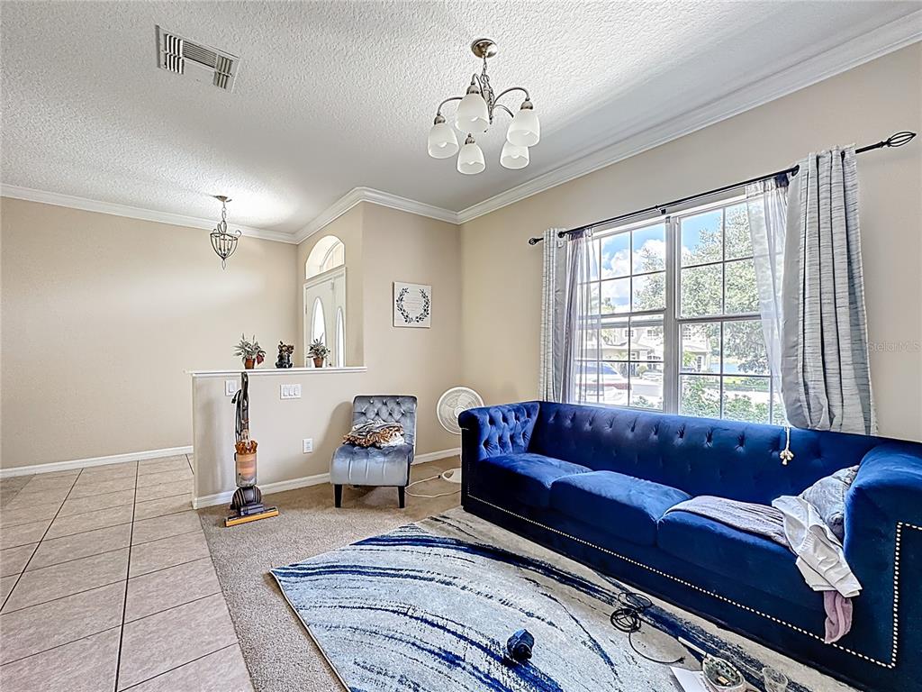 1692 Scrub Jay Road Apopka, FL 32703 - Photo 30 of 35 a living room with furniture and a large window