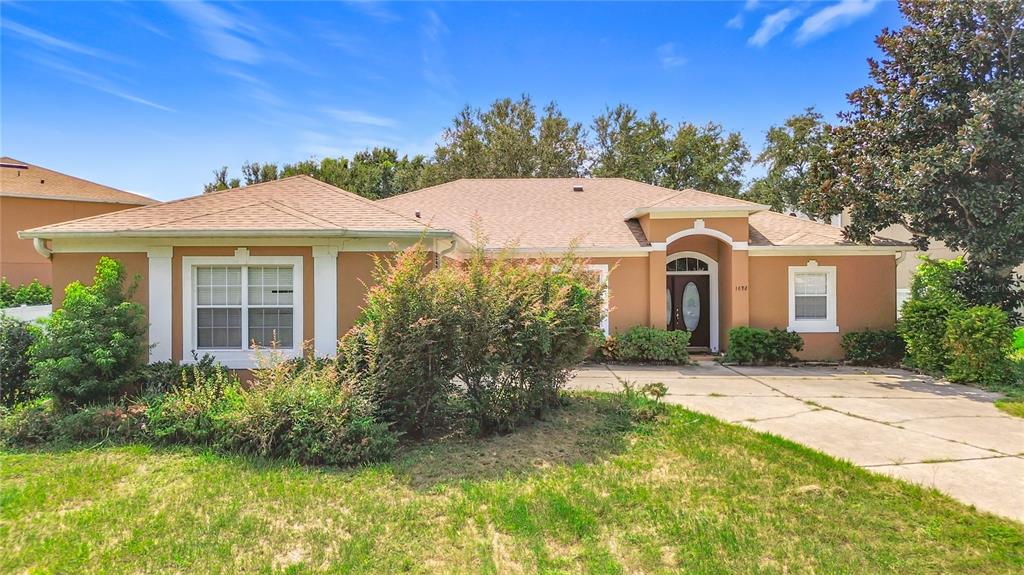 1692 Scrub Jay Road Apopka, FL 32703 - Photo 35 of 35 a front view of a house with a yard