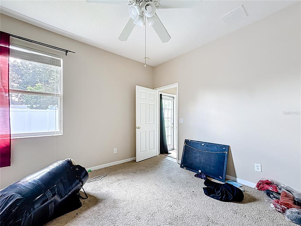 1692 Scrub Jay Road Apopka, FL 32703 - Photo 10 of 35 a living room with furniture a bed and a chandelier