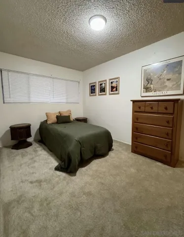 a bedroom with a bed and a cabinets