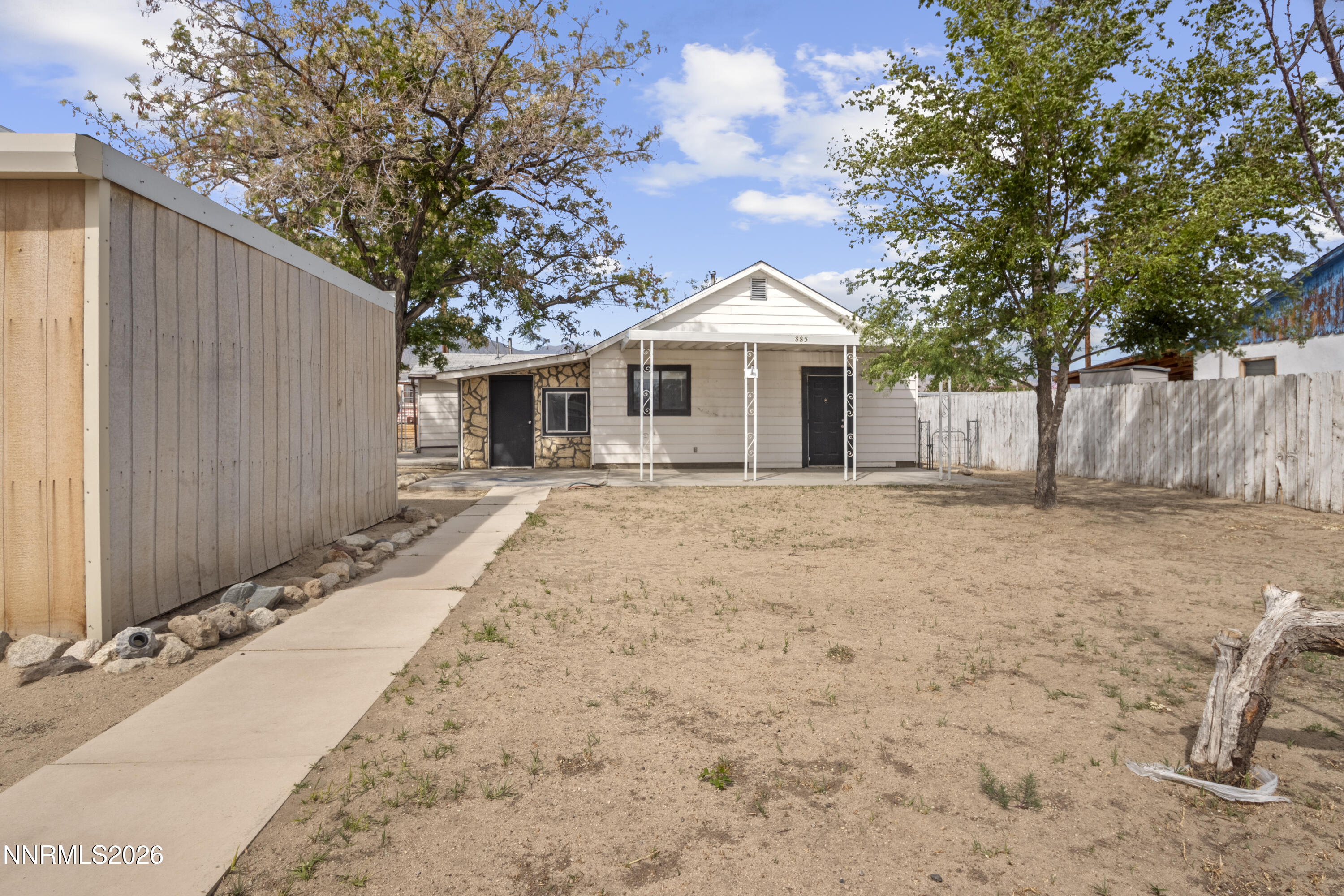 885 I Street Hawthorne, NV 89415 - Photo 4 of 20 a front view of a house with a yard and potted plants