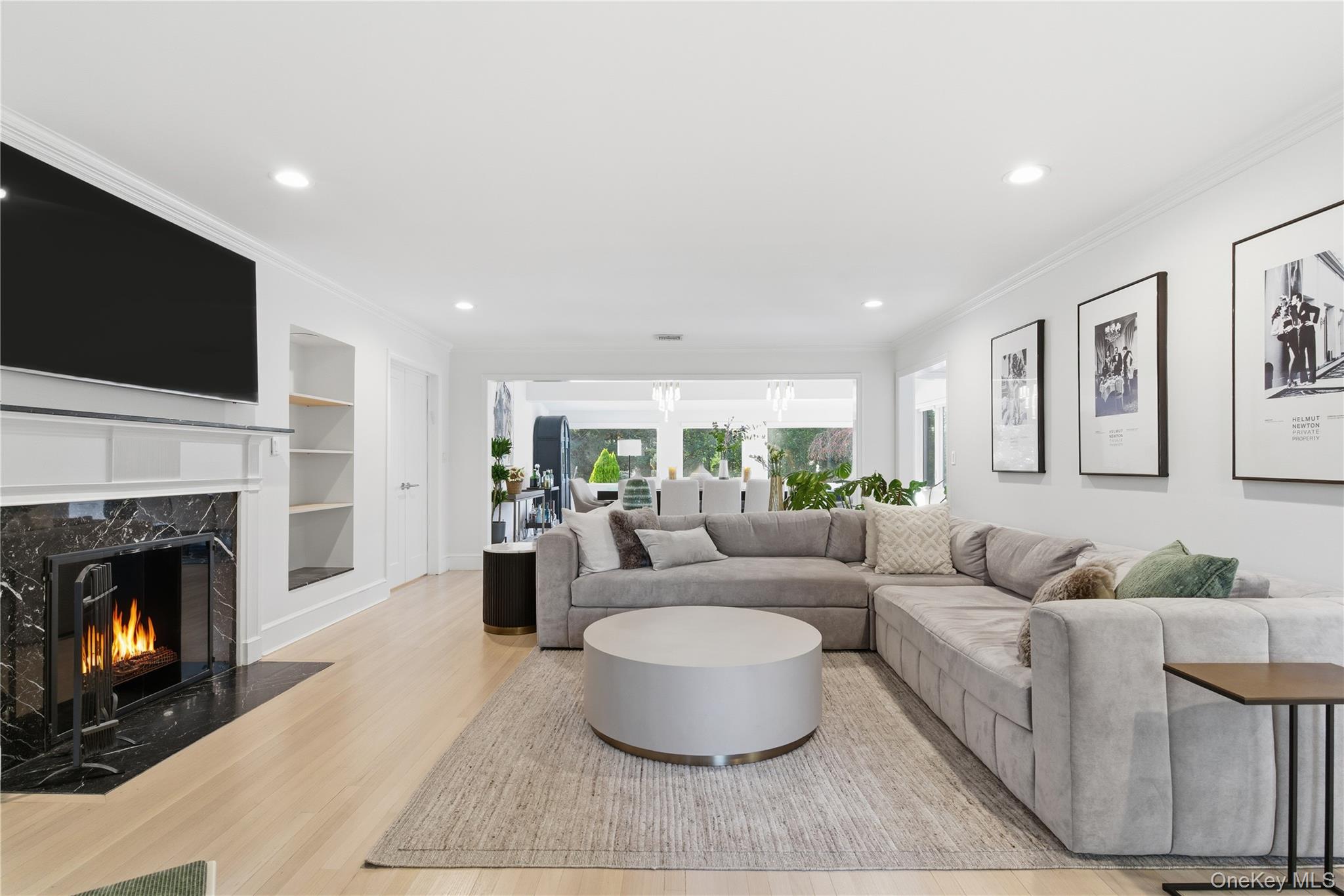 108 Bacon Road Old Westbury, NY 11568 - Photo 11 of 39 a living room with furniture a fireplace and a flat screen tv