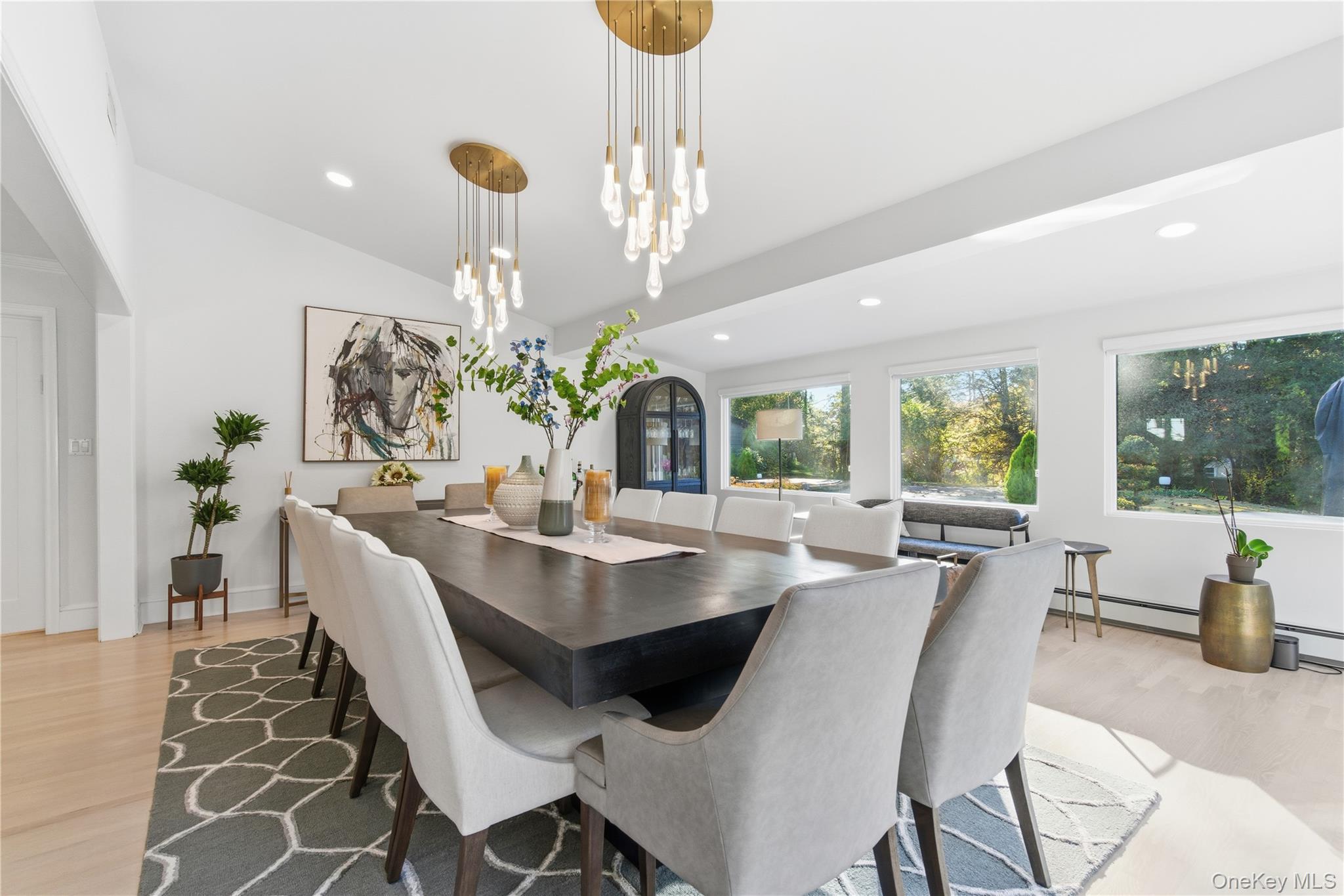 108 Bacon Road Old Westbury, NY 11568 - Photo 14 of 39 a dining room with furniture a potted plant and a chandelier