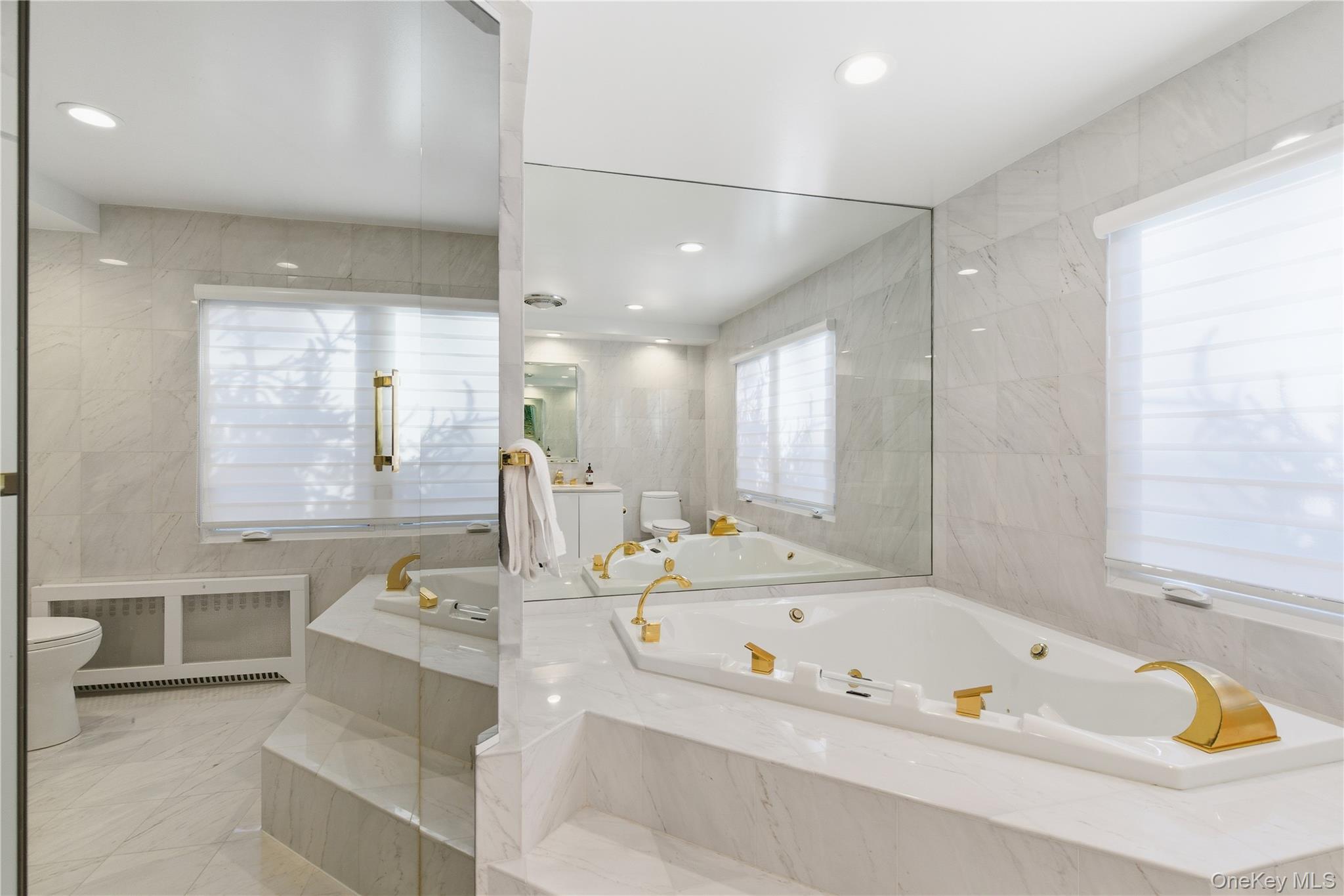 108 Bacon Road Old Westbury, NY 11568 - Photo 19 of 39 a bathroom with a tub a sink and a window