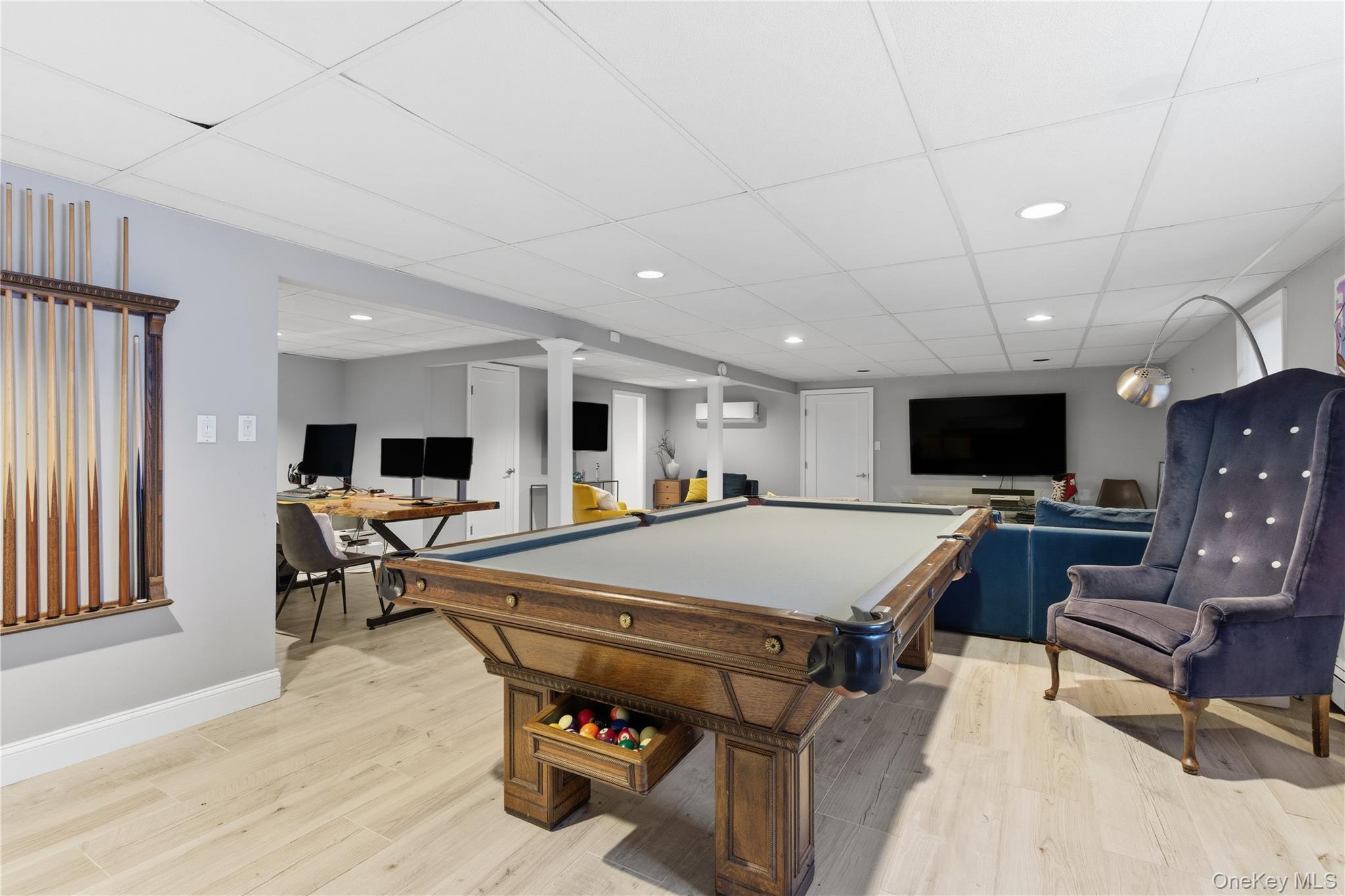 108 Bacon Road Old Westbury, NY 11568 - Photo 27 of 39 a living room with furniture a flat screen tv and a table