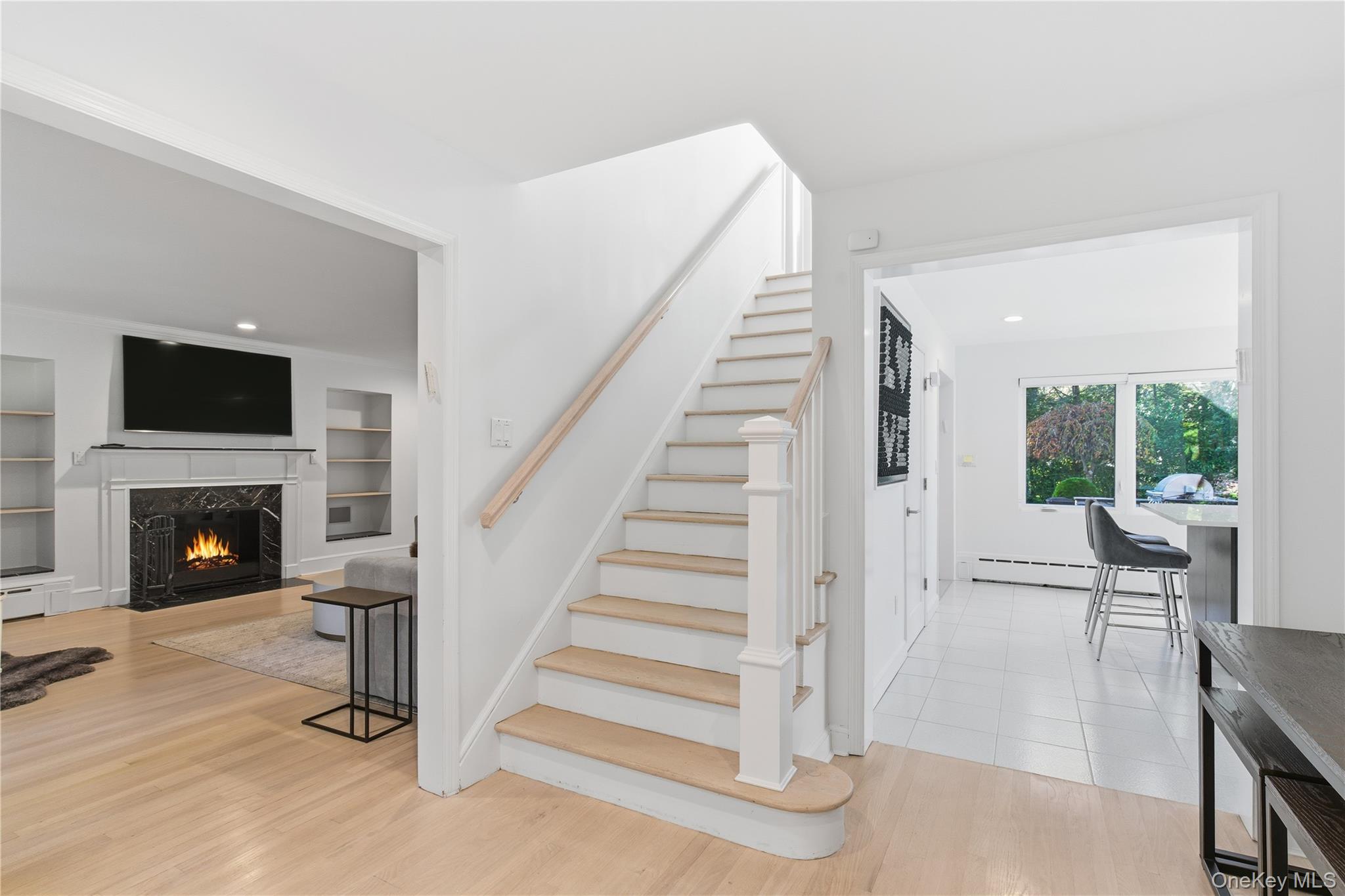 108 Bacon Road Old Westbury, NY 11568 - Photo 4 of 39 a view of a livingroom with furniture and a fireplace