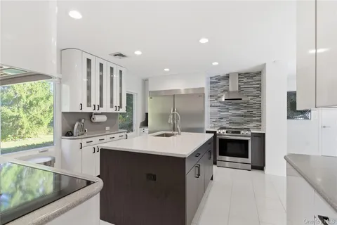 a kitchen with a sink stove top oven and cabinets