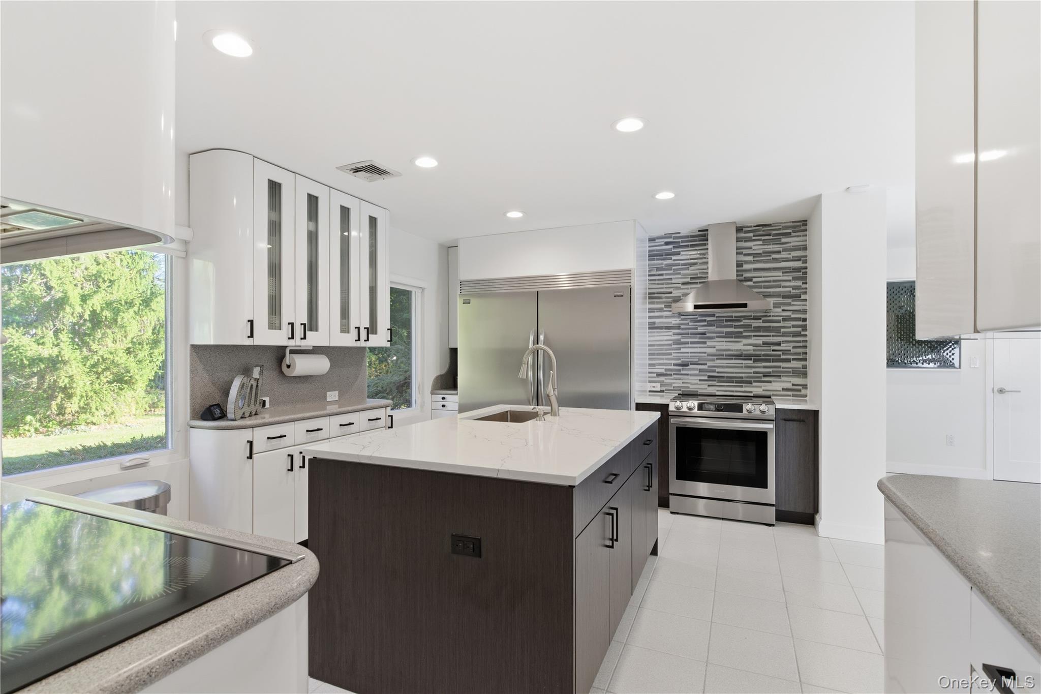 108 Bacon Road Old Westbury, NY 11568 - Photo 7 of 39 a kitchen with a sink stove top oven and cabinets