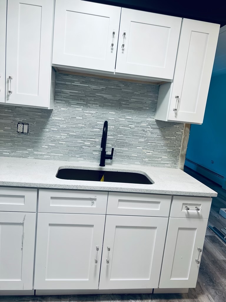 2345 185th Court, Unit 16 Lansing, IL 60438 - Photo 6 of 12 a kitchen with white cabinets and white appliances