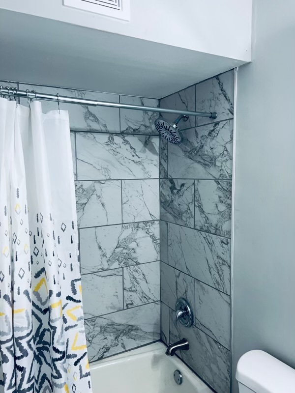 2345 185th Court, Unit 16 Lansing, IL 60438 - Photo 8 of 12 a bathroom with a shower and a toilet