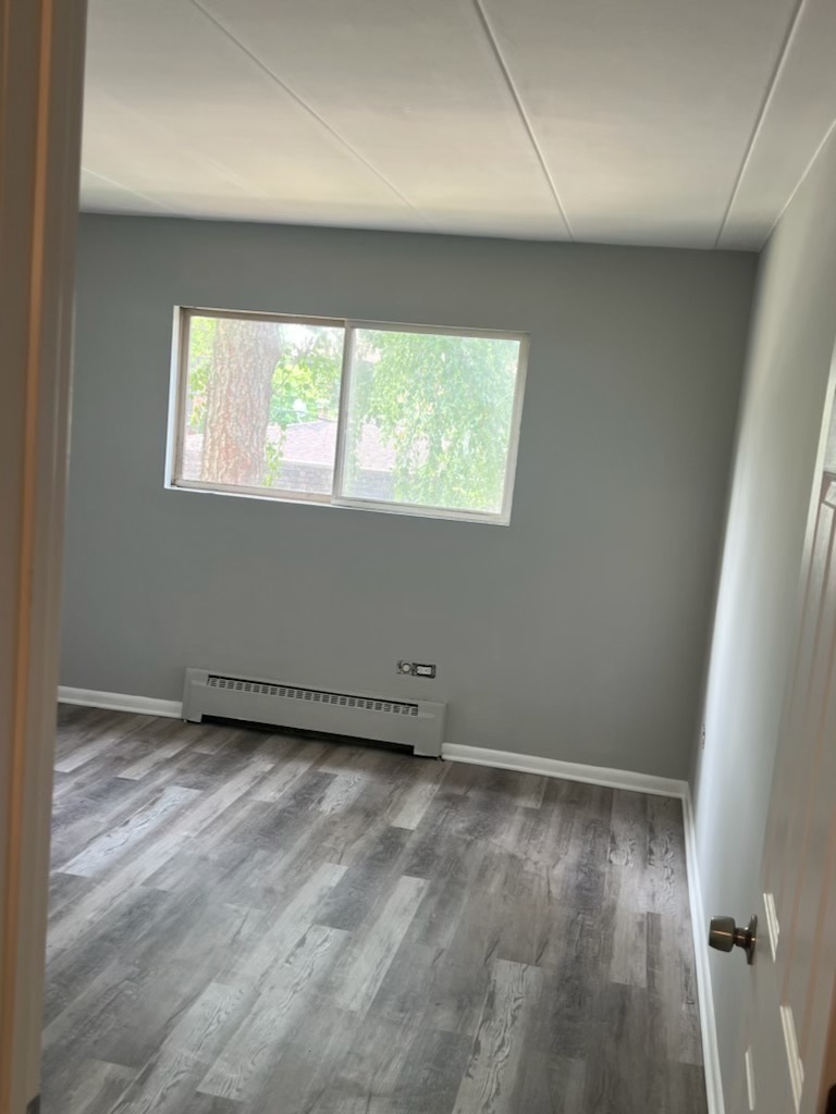 2345 185th Court, Unit 16 Lansing, IL 60438 - Photo 10 of 12 an empty room with wooden floor and windows