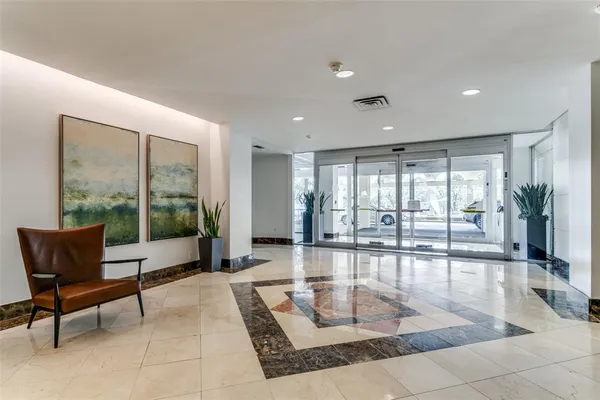 a living room with furniture and large windows