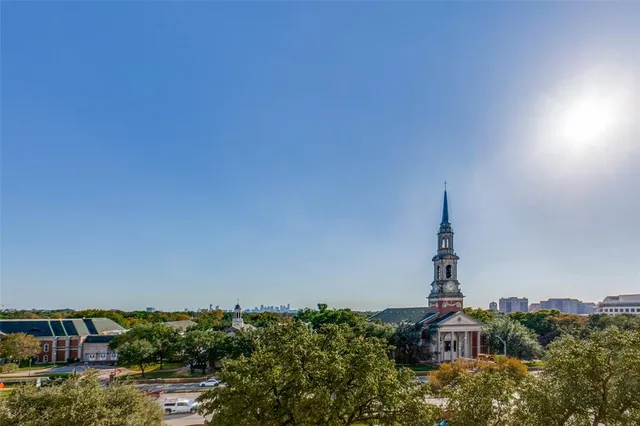 a view of a balcony with wooden floor and fence