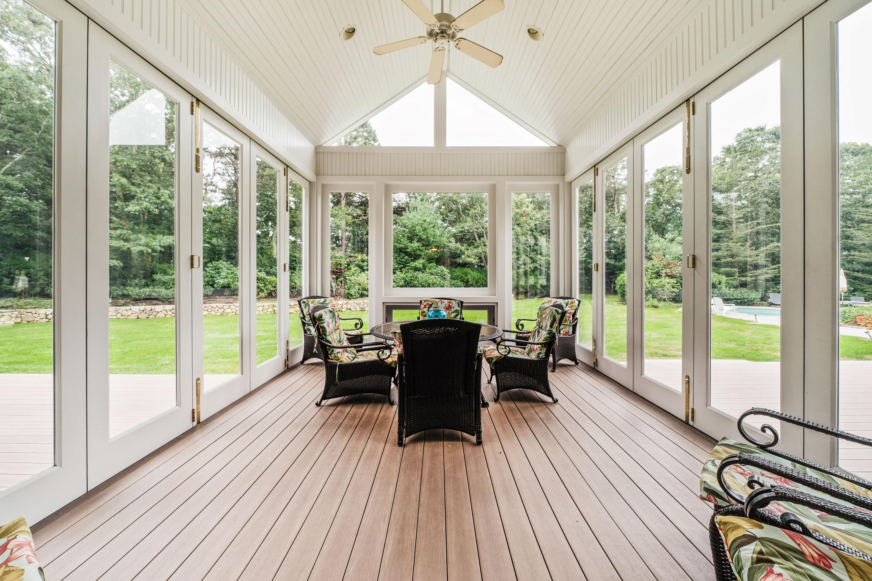87 Seapuit Road Osterville, MA 02655 - Photo 13 of 39 a dining room with furniture wooden floor a chandelier and a floor to ceiling window