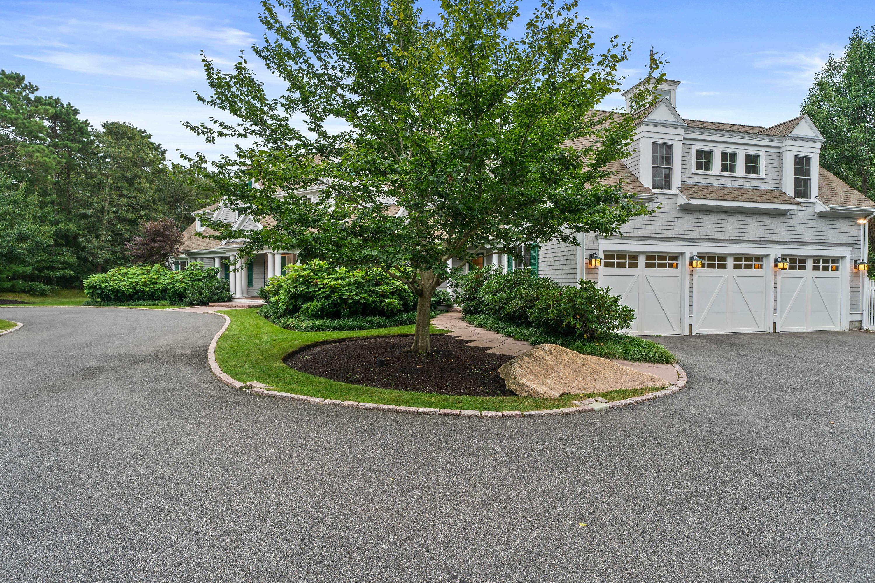 87 Seapuit Road Osterville, MA 02655 - Photo 33 of 39 a view of a house with a yard and garage