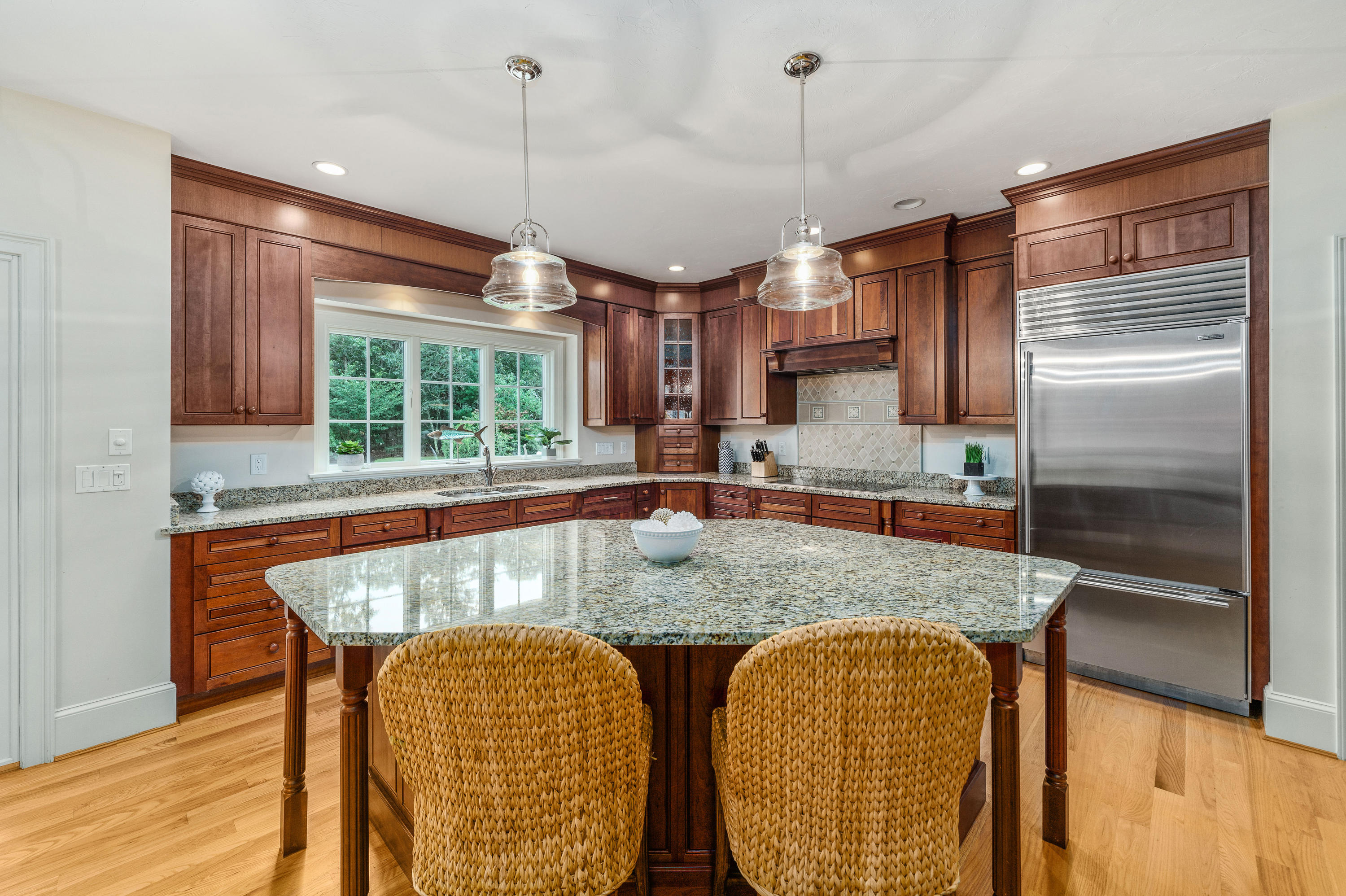 87 Seapuit Road Osterville, MA 02655 - Photo 6 of 39 a kitchen with granite countertop a table chairs in it and wooden floors