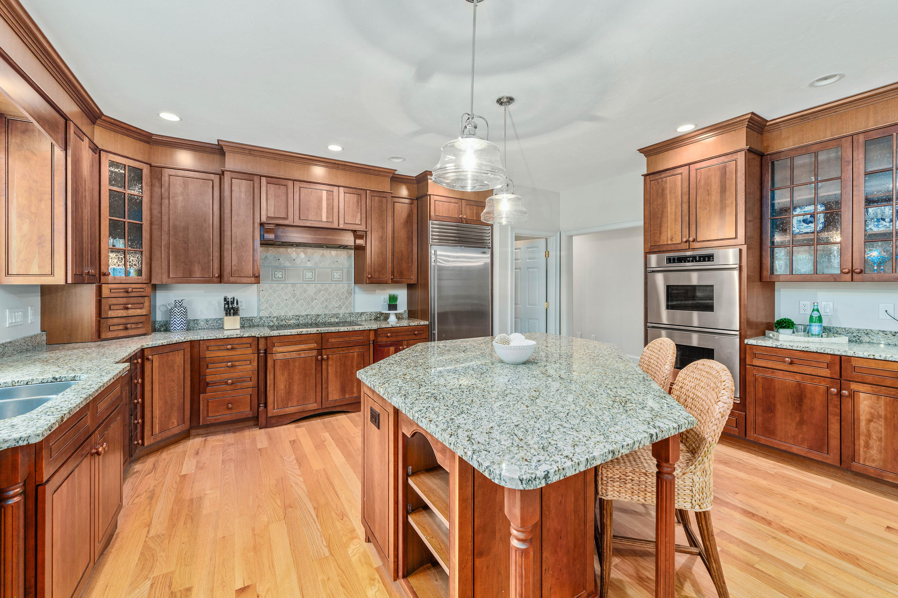 87 Seapuit Road Osterville, MA 02655 - Photo 7 of 39 a kitchen with stainless steel appliances granite countertop a kitchen island a stove a sink cabinets and wooden floor