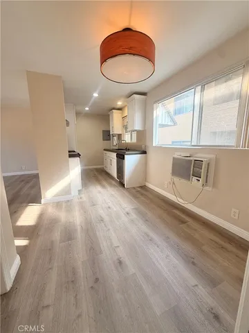 a living room with stainless steel appliances furniture and a large window