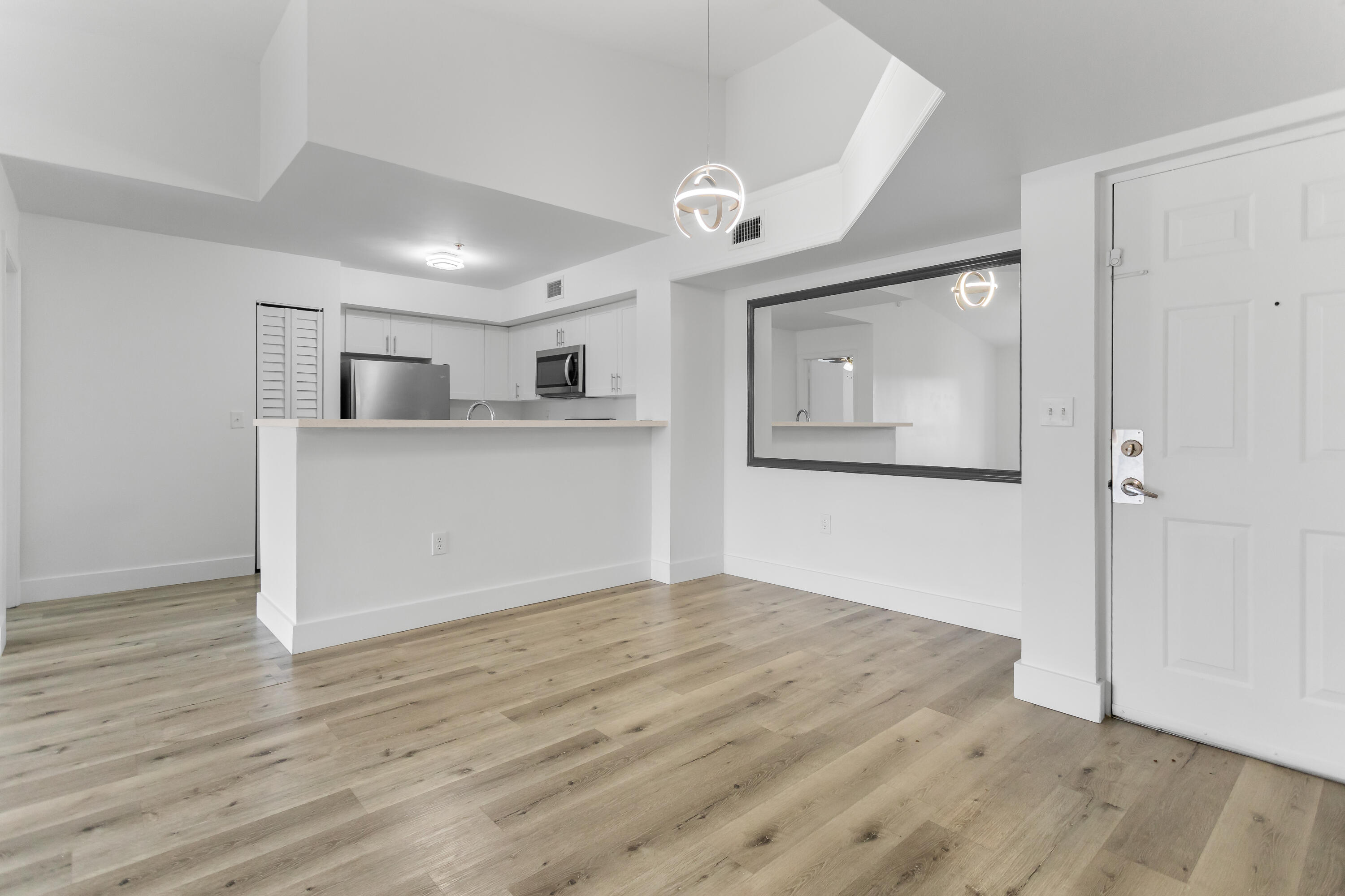2113 Renaissance Boulevard, Unit 306 Miramar, FL 33025 - Photo 12 of 59 a view of a kitchen with wooden floor and a ceiling fan