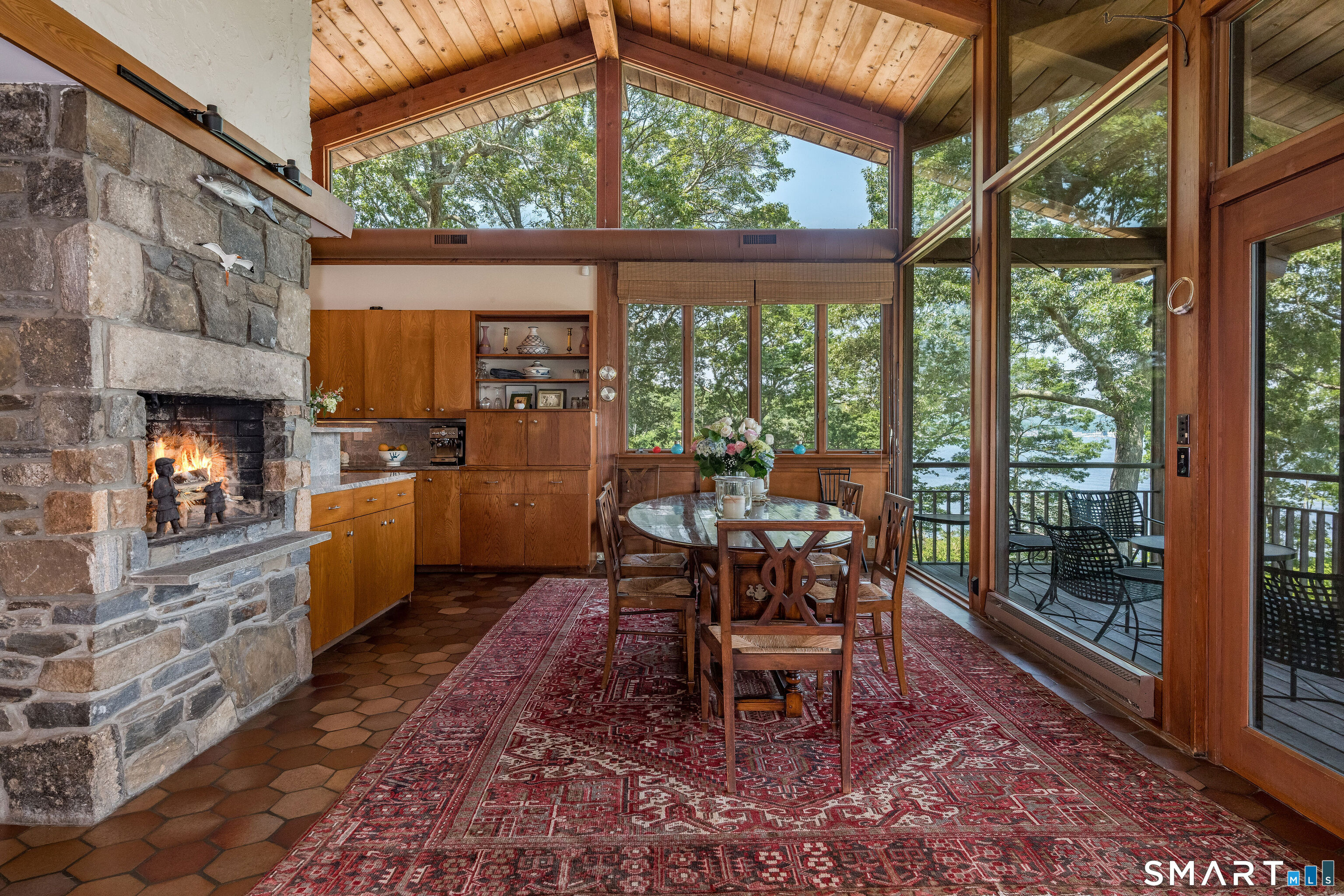 41 Watrous Point Road Old Saybrook, CT 06475 - Photo 19 of 40 a dining room with furniture and a fireplace