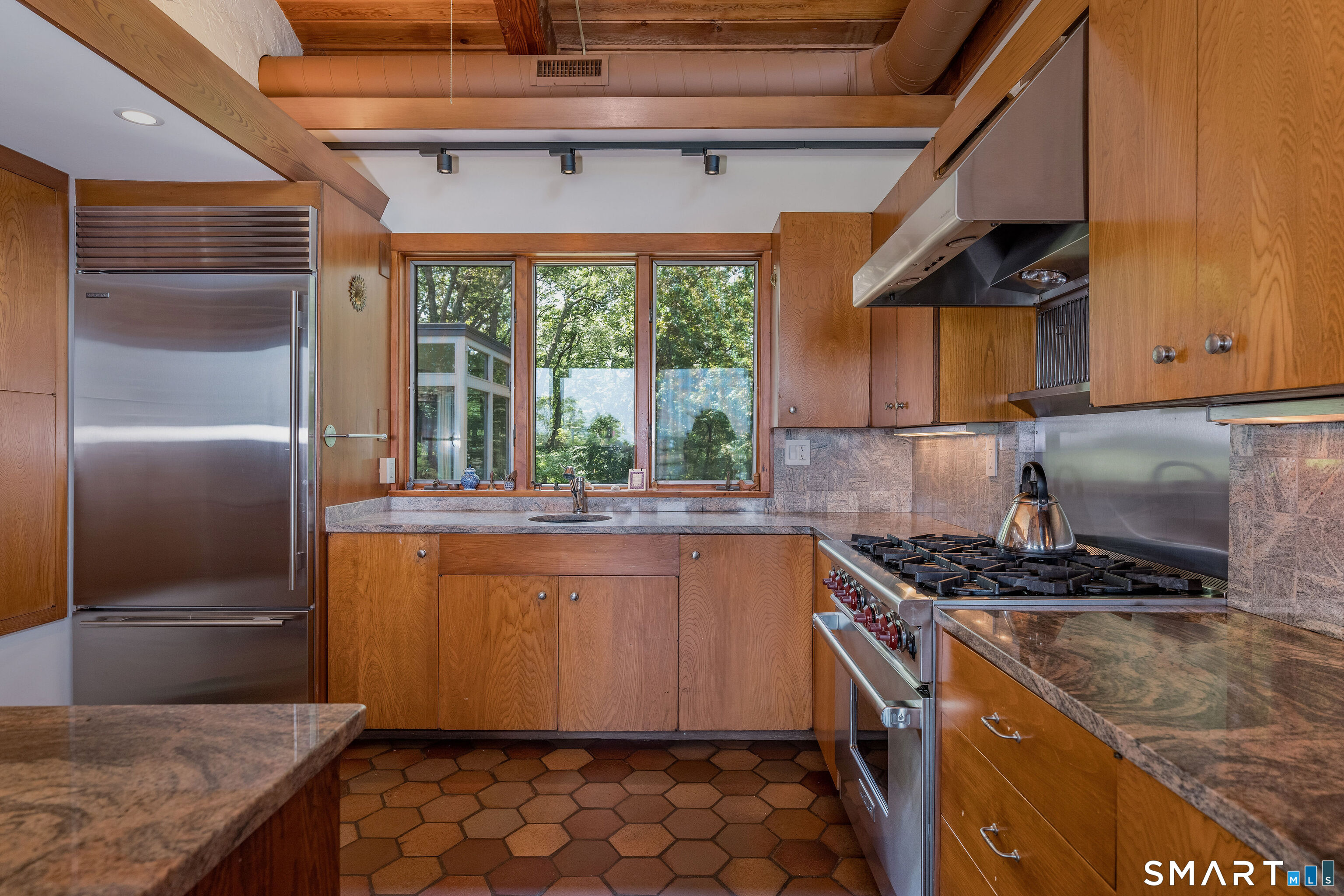 41 Watrous Point Road Old Saybrook, CT 06475 - Photo 21 of 40 a kitchen with stainless steel appliances granite countertop a stove a sink and a refrigerator