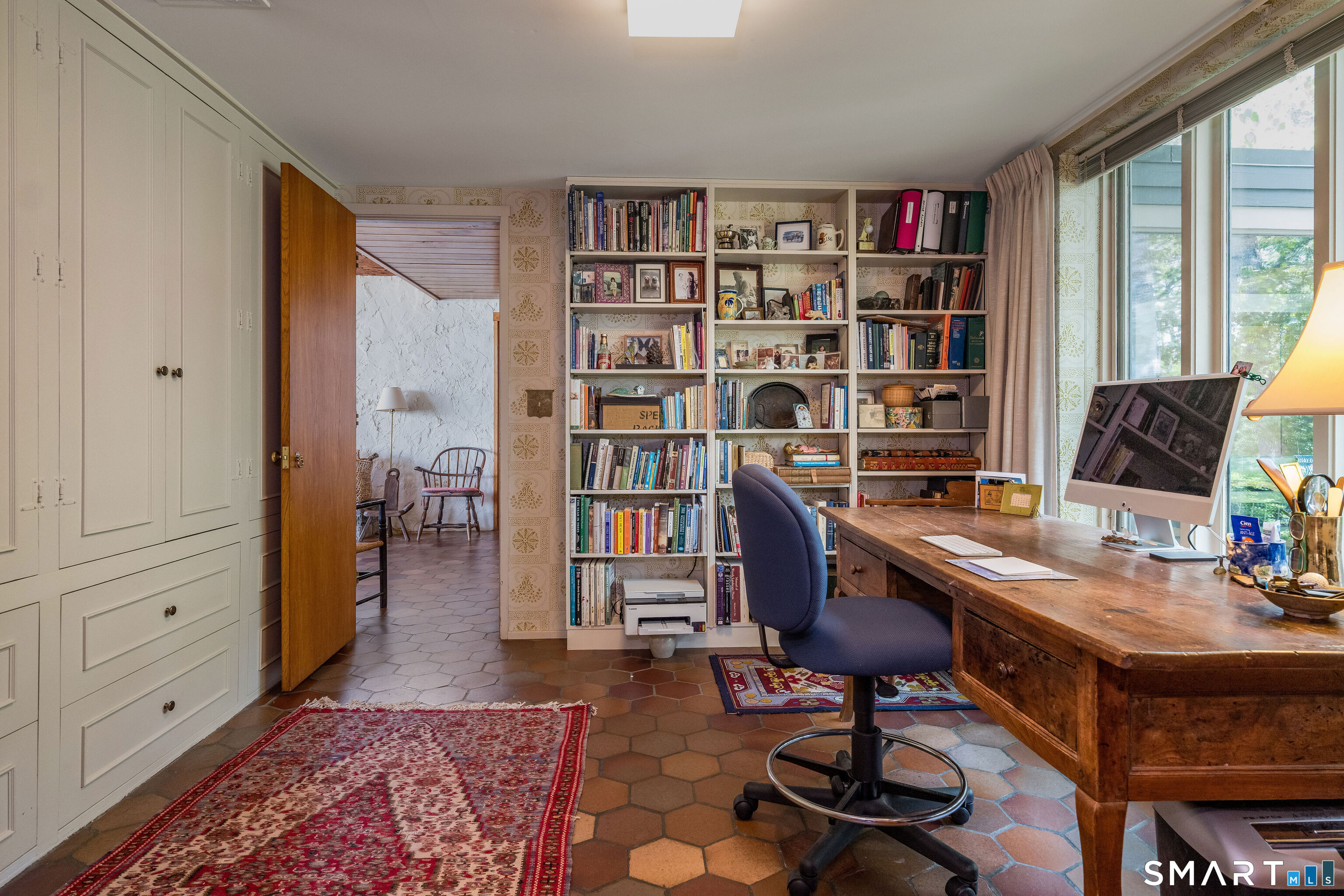 41 Watrous Point Road Old Saybrook, CT 06475 - Photo 23 of 40 a view of a workspace with furniture and a bookshelf
