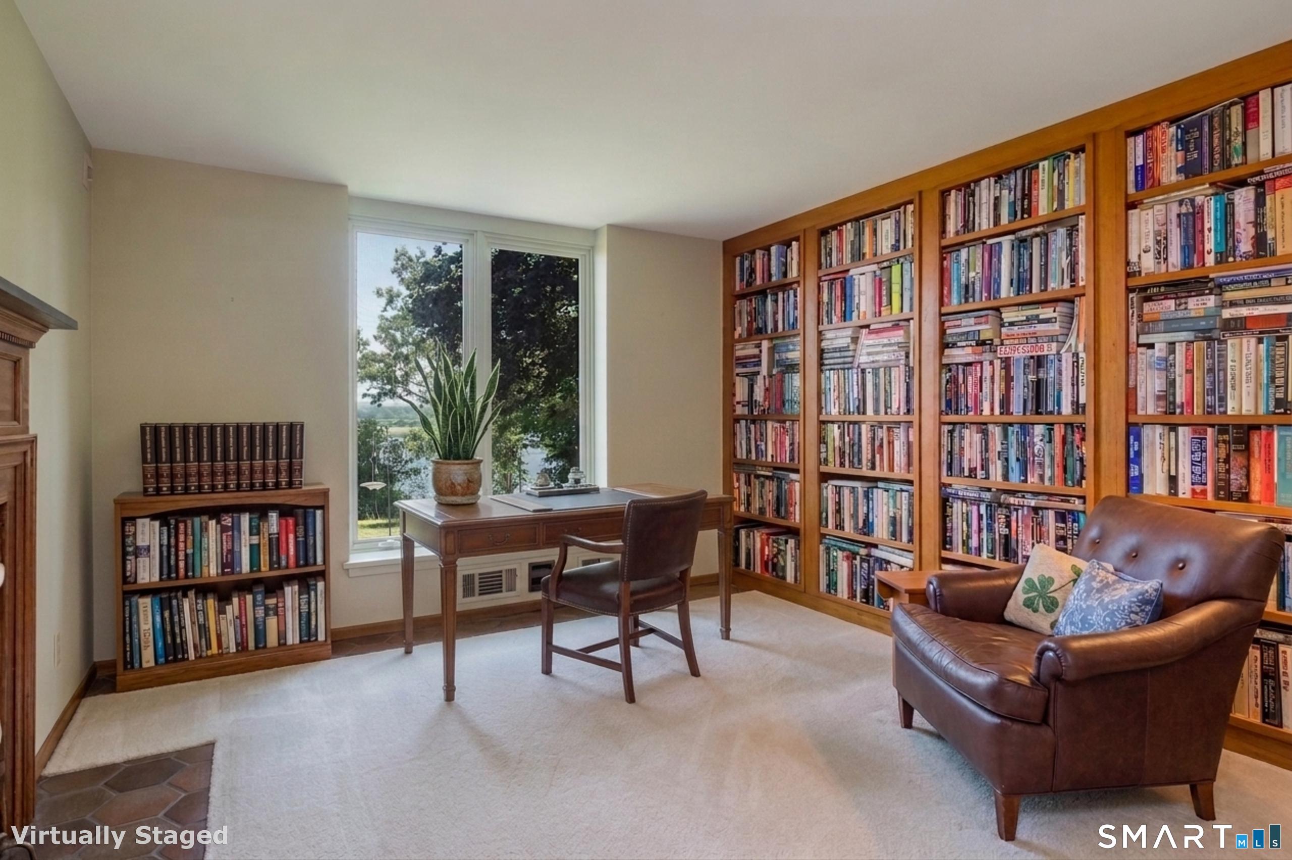 41 Watrous Point Road Old Saybrook, CT 06475 - Photo 24 of 40 a living room with furniture a bookshelf and a window
