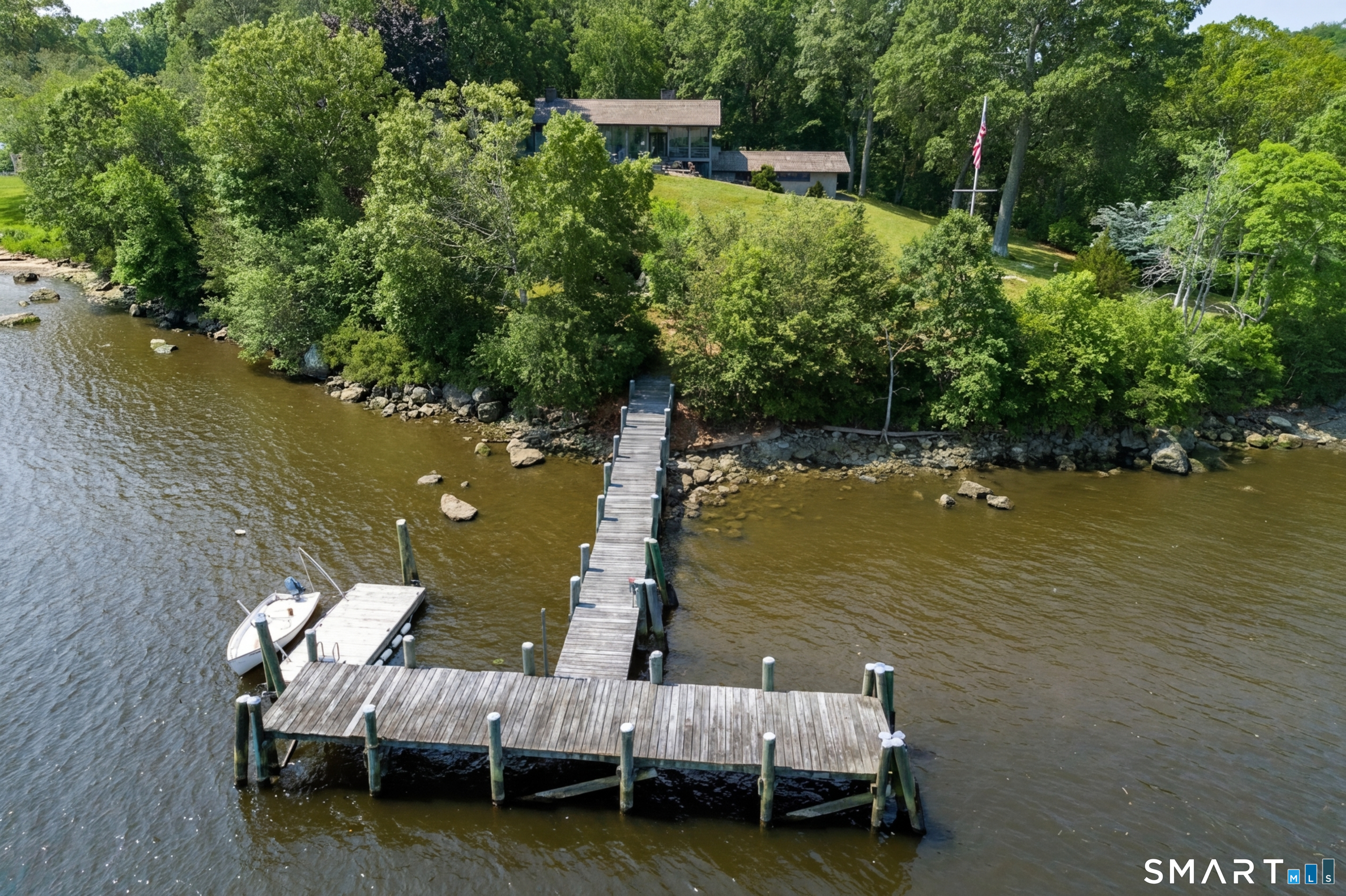 41 Watrous Point Road Old Saybrook, CT 06475 - Photo 3 of 40 a view of a lake with couches chairs and swimming pool
