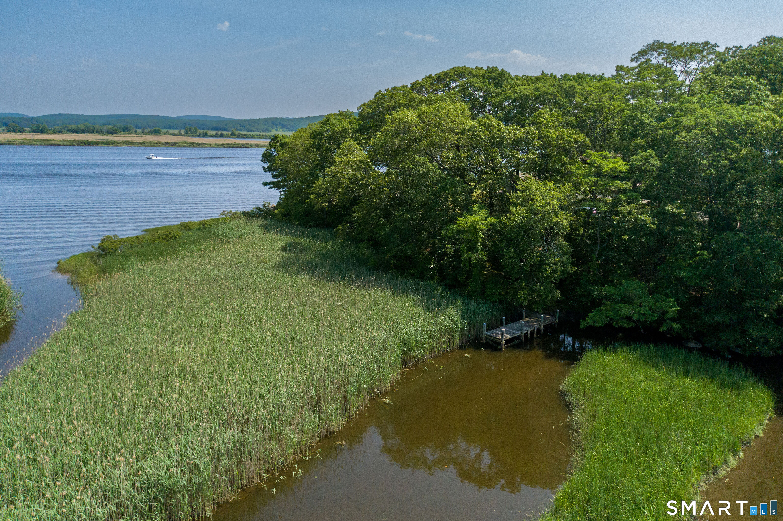 41 Watrous Point Road Old Saybrook, CT 06475 - Photo 5 of 40 a view of a water pond with green yard