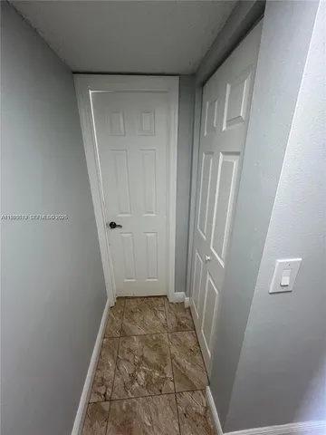 a view of an empty room and wooden floor