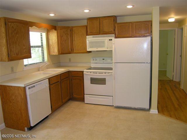 100 Cat Road Ponte Vedra Beach, FL 32082 - Photo 5 of 14 a kitchen with a sink a refrigerator and window