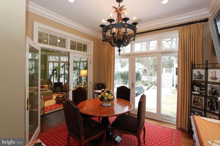 7402 Fairfax Road Bethesda, MD 20814 - Photo 11 of 30 a view of a dining room with furniture wooden floor and chandelier