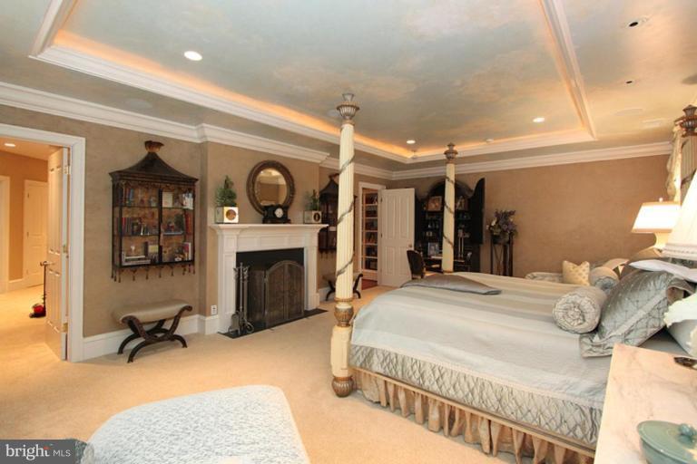 7402 Fairfax Road Bethesda, MD 20814 - Photo 13 of 30 a bedroom with furniture and a fireplace
