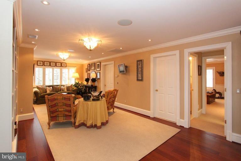 7402 Fairfax Road Bethesda, MD 20814 - Photo 15 of 30 a living room with furniture a dining table and wooden floor