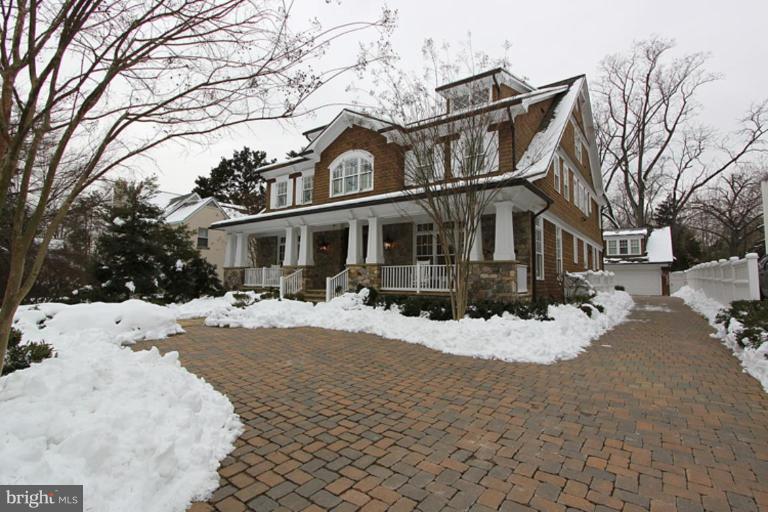 7402 Fairfax Road Bethesda, MD 20814 - Photo 20 of 30 a view of a white house with a yard covered in snow