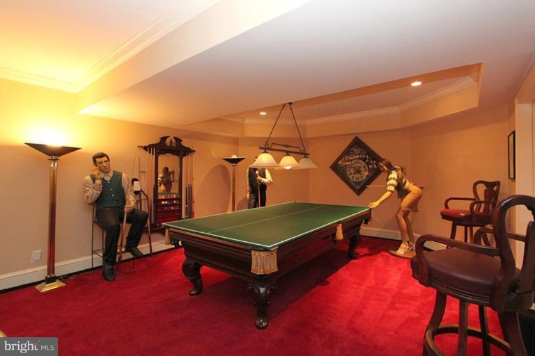 7402 Fairfax Road Bethesda, MD 20814 - Photo 22 of 30 a living room with a table tennis air hockey table and arcade game machine