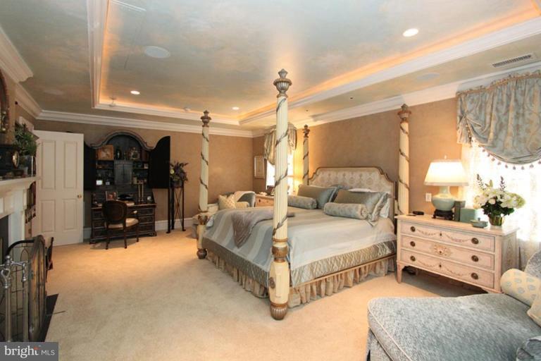 7402 Fairfax Road Bethesda, MD 20814 - Photo 6 of 30 a spacious bedroom with a bed and a walk in closet