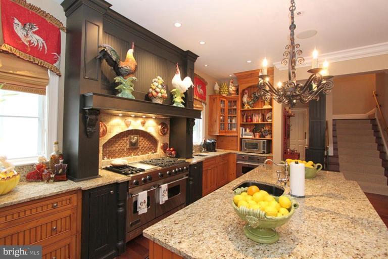 7402 Fairfax Road Bethesda, MD 20814 - Photo 10 of 30 a kitchen with stainless steel appliances granite countertop a stove a sink and a wooden cabinets
