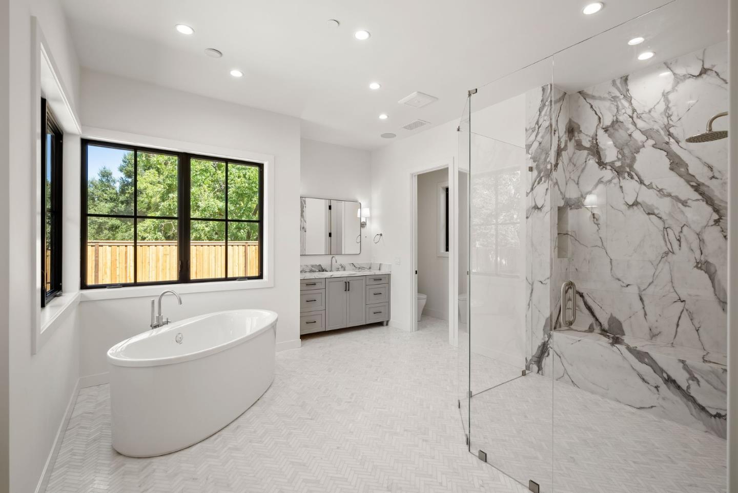 18521 Vessing Road Saratoga, CA 95070 - Photo 20 of 36 a bathroom with a tub sink shower and mirror