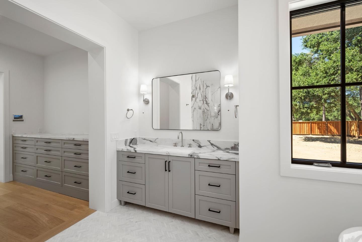 18521 Vessing Road Saratoga, CA 95070 - Photo 22 of 36 a bathroom with a granite countertop sink vanity mirror next to a window