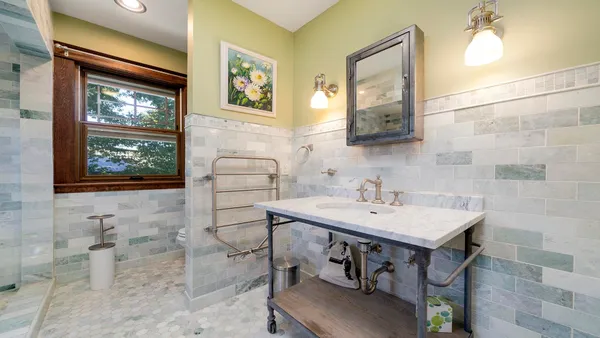 a bathroom with a sink a toilet and mirror