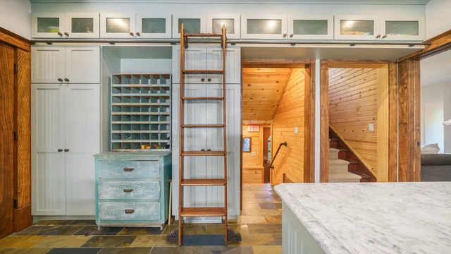 a bathroom with a sink a bathtub and next to a window