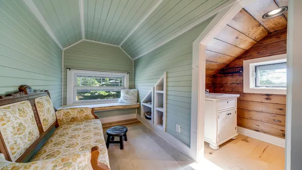 a spacious bedroom with a bed and a window