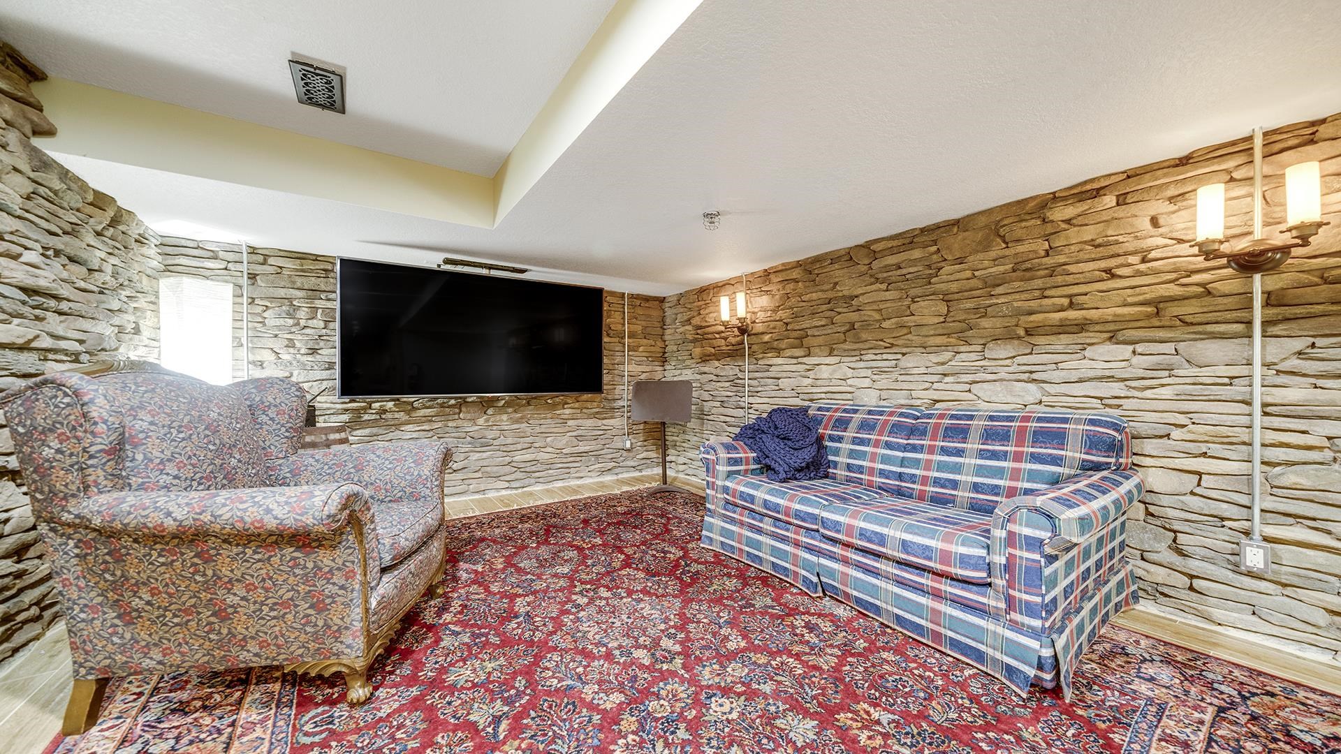 409 North State Street Franklin Grove, IL 61031 - Photo 59 of 98 a living room with couches bookshelf and a flat screen tv