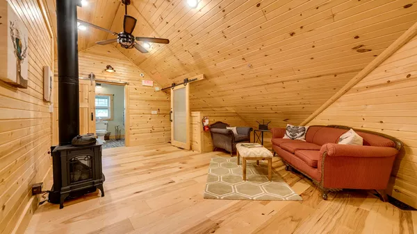 a living room filled with furniture hardwood floor and a large window