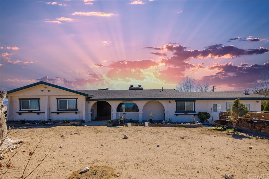 10707 Post Office Road Lucerne Valley, CA 92356 - Photo 1 of 1 a front view of a house with a yard covered with snow