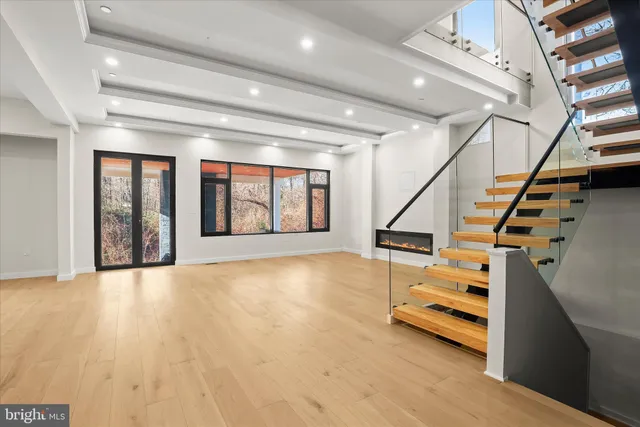 a large kitchen with stainless steel appliances a large counter top a stove and a sink