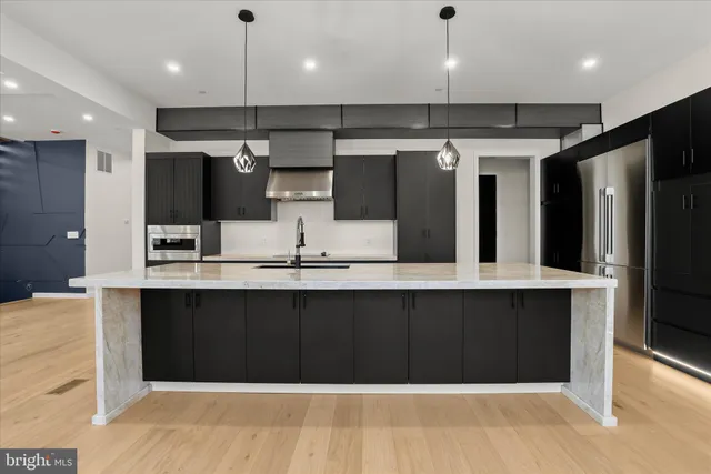 a kitchen with a sink and a refrigerator