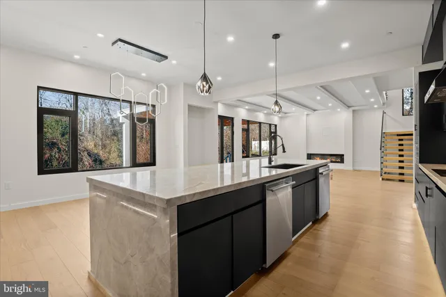 a view of an empty room with a fireplace and a window