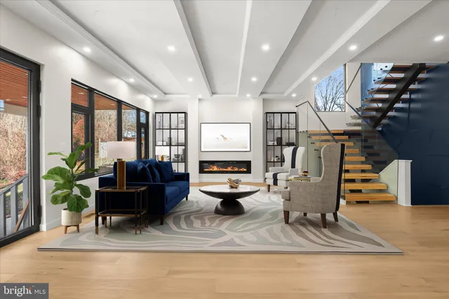 a living room with furniture gym equipment and a large window